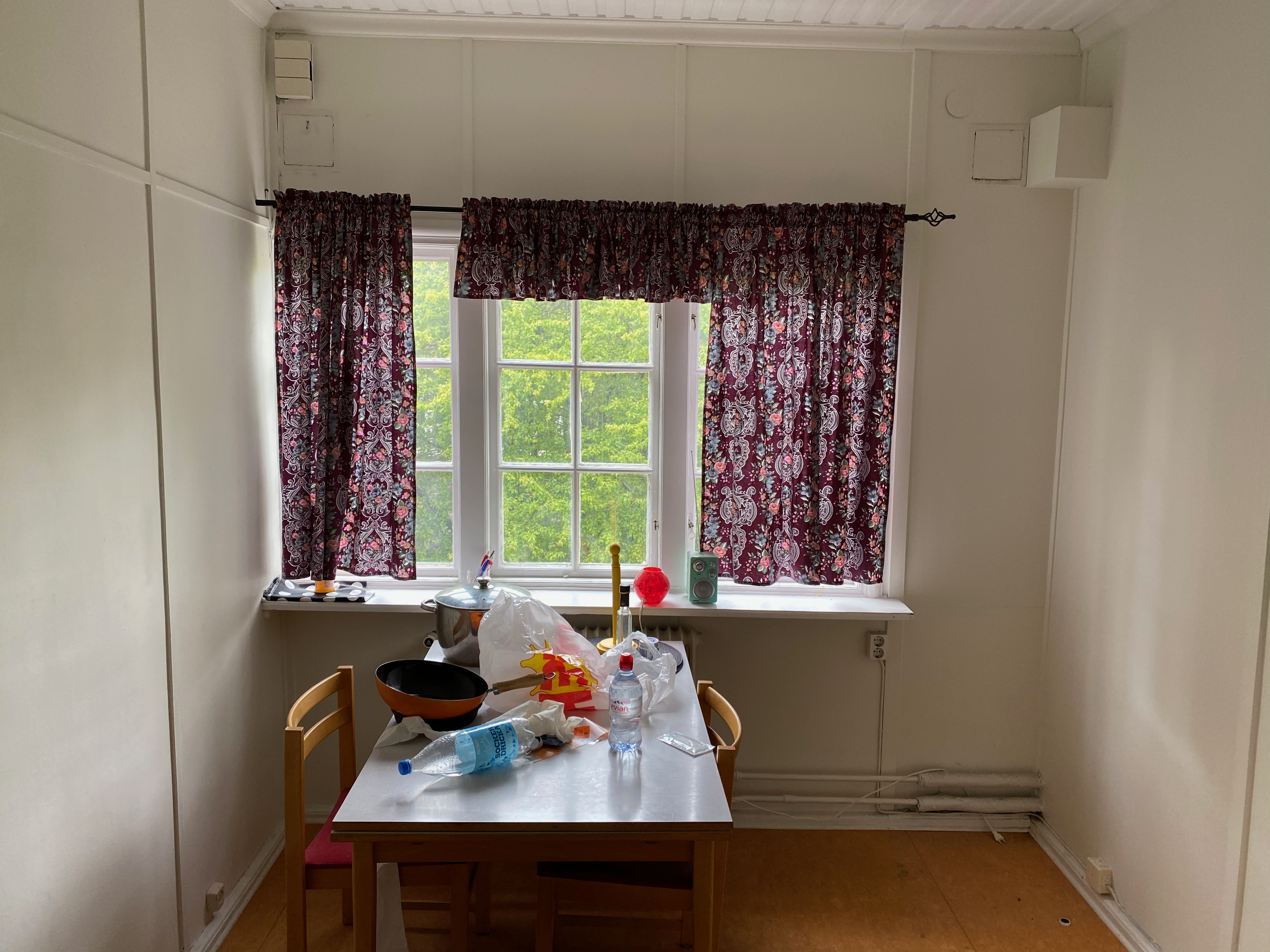 Liten matplats med blommiga gardiner